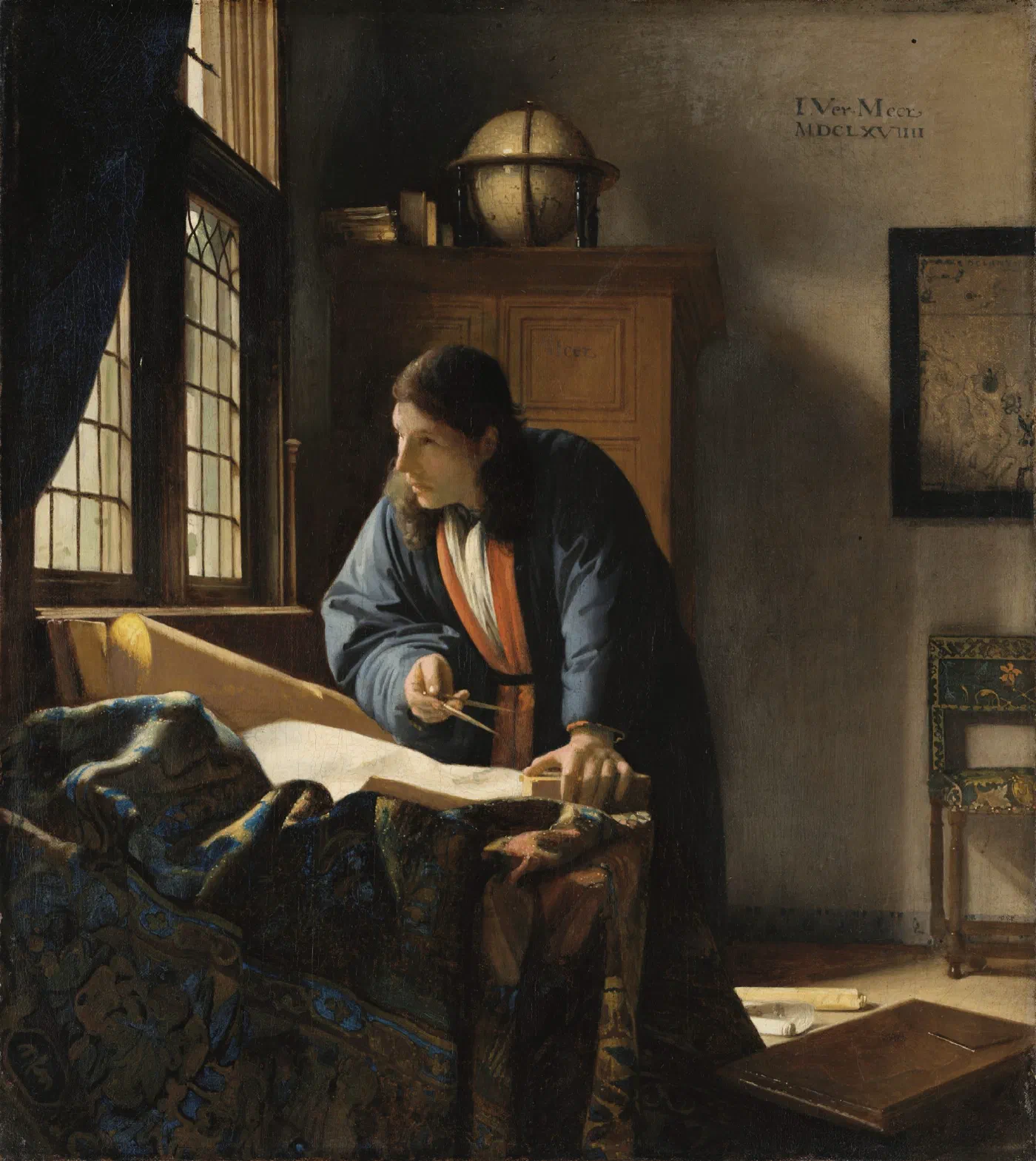 The Geographer by Johannes Vermeer (1669), a scholar at a desk by a window with a map in front of him, dividers in hand, a globe on the cupboard behind him and a chart on the wall.